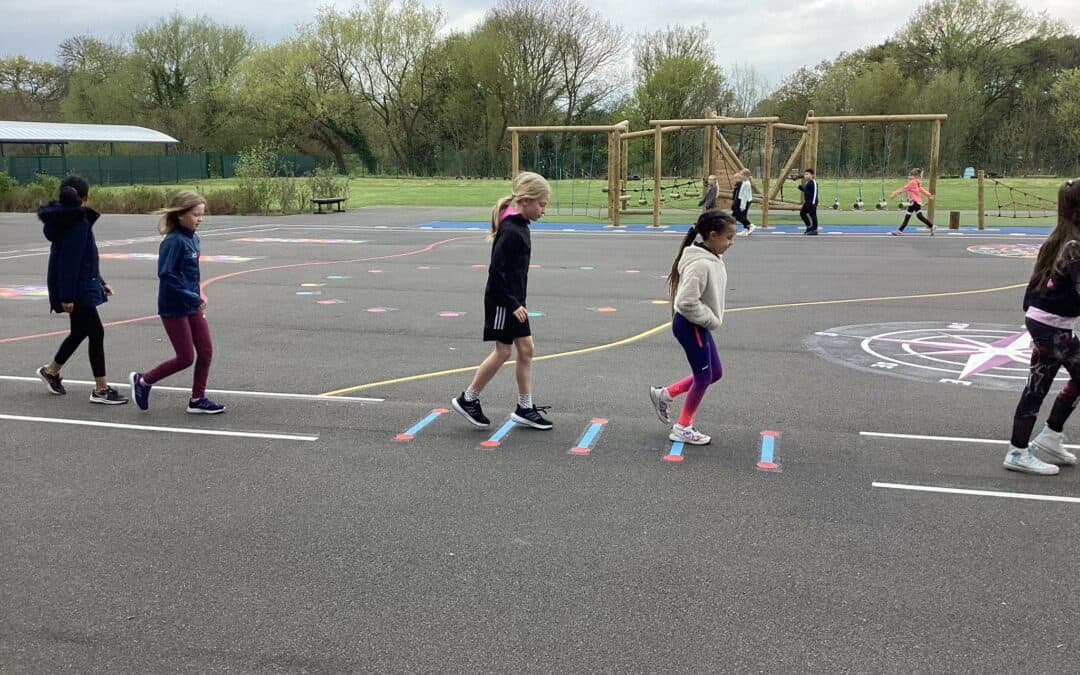 Pupils in Year 4 hop across the new playground markings during their section of the walk