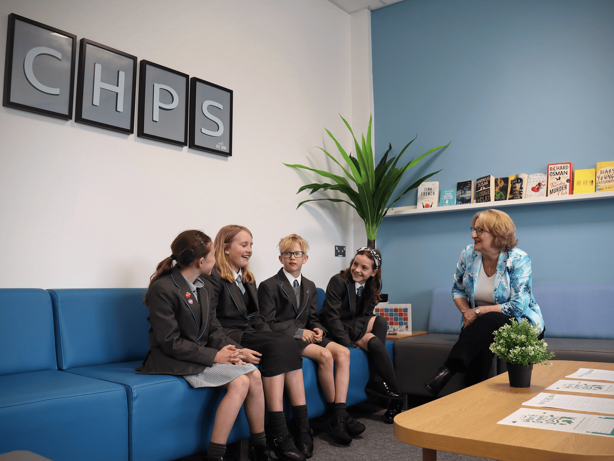 Pupils sat with Mary Robinson MP discussing their life at Cheadle Hulme Primary School