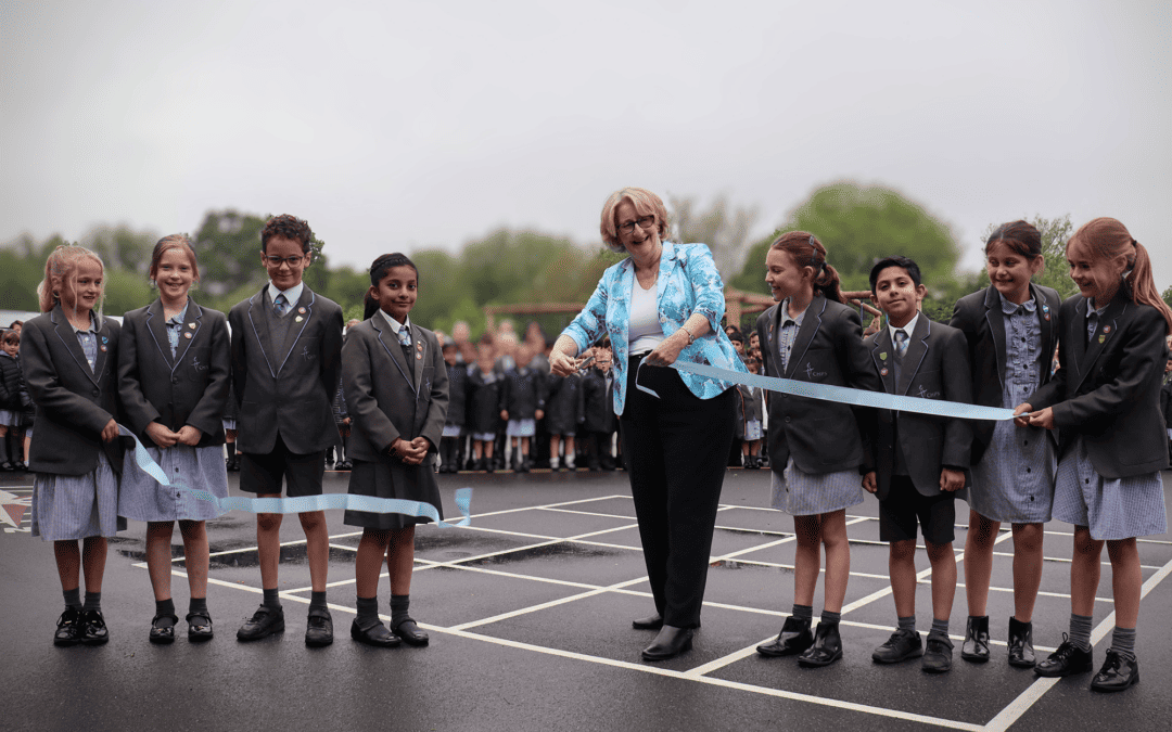 Mary Robinson MP cutting the ribbon to open the school playground with the help of school pupils.