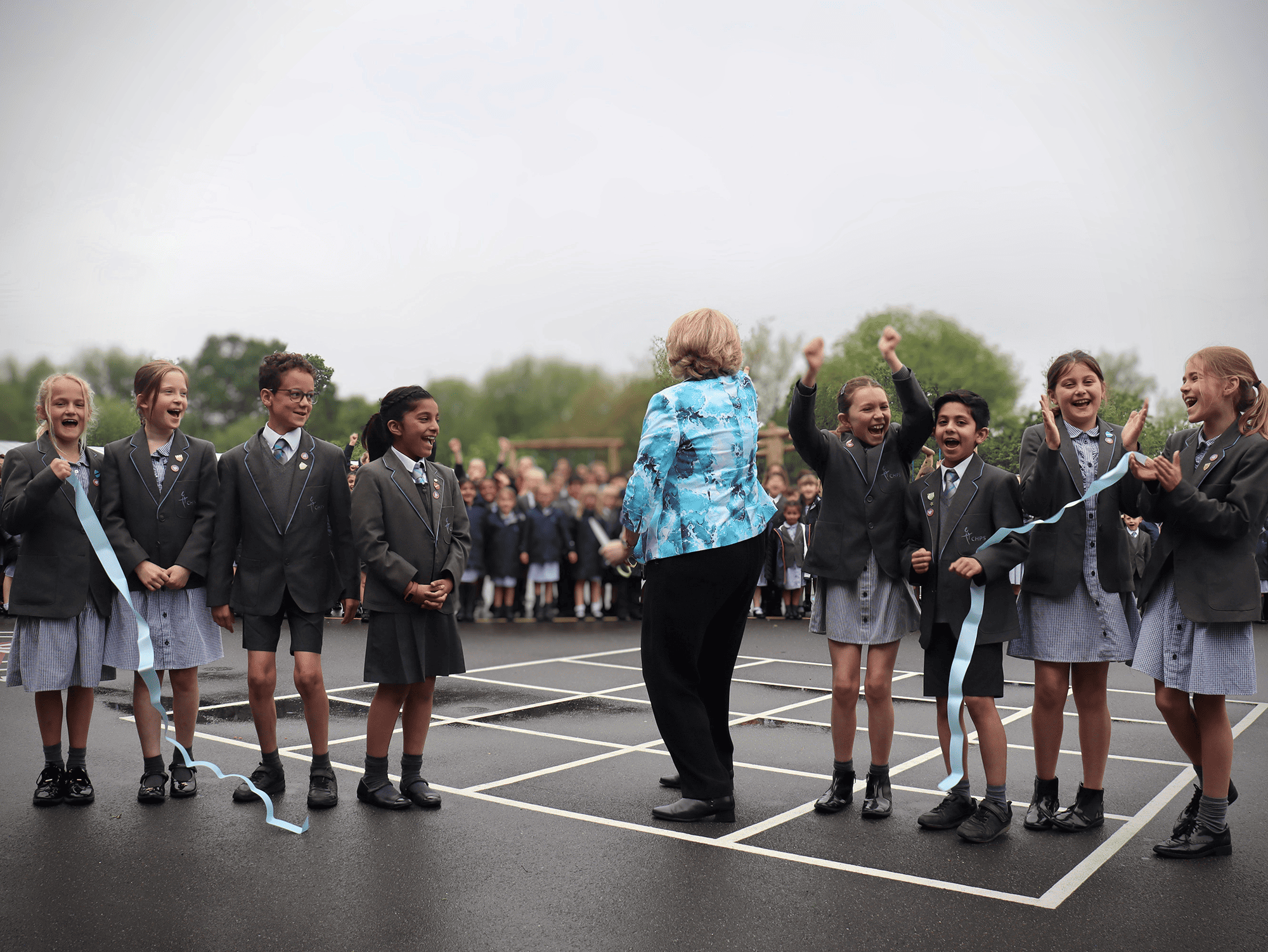 Mary Robinson MP and pupils celebrating the opening of their playground.