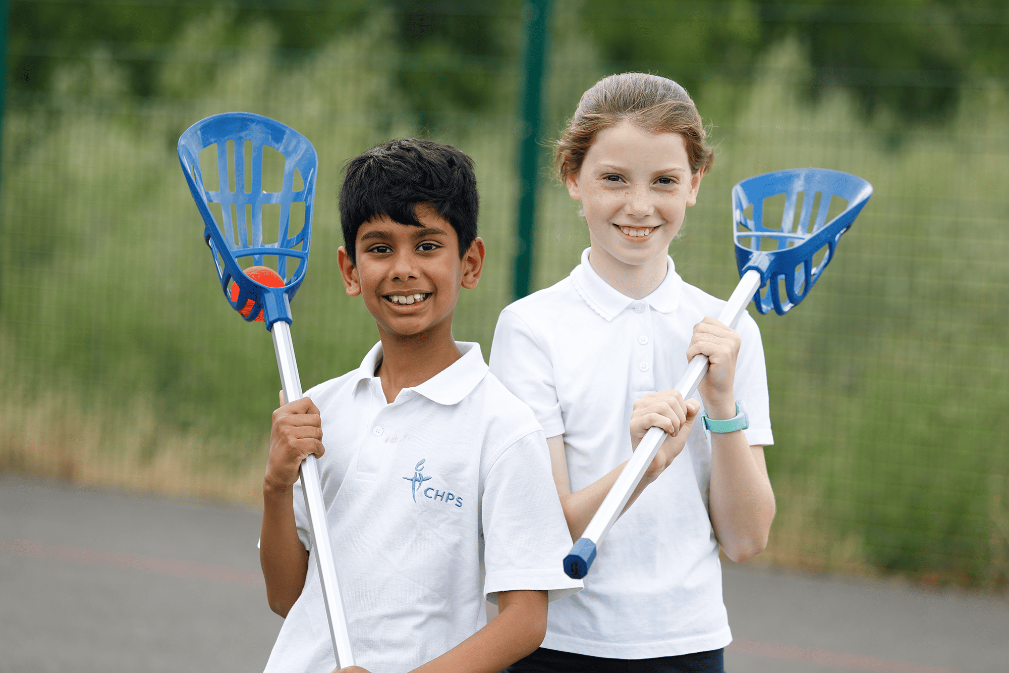 Cheadle Hulme Primary School pupils in PE playing lacrosse.