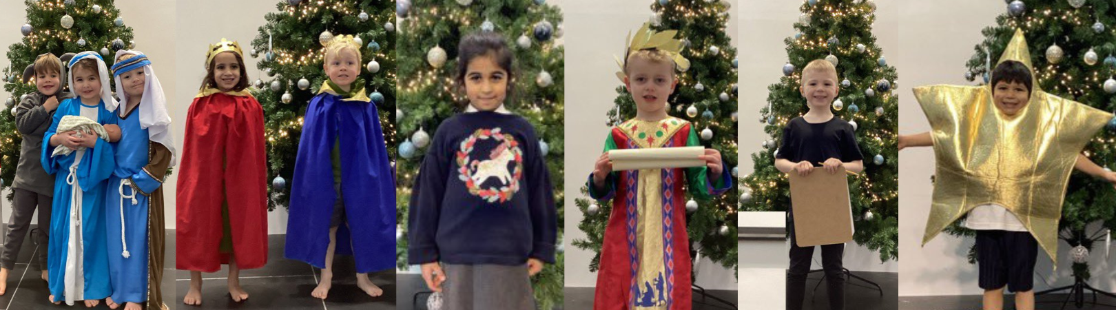 Children pose in front of the Christmas tree in their nativity costumes